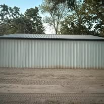 Completed metal shop building exterior with standing seam roof in Northeast Texas