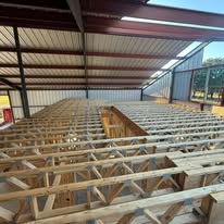 Loft and attic floor framing inside a barndominium built by Elite Solutions of Texas